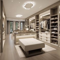 a large walk in closet with white furniture