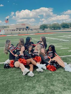 the cheerleaders are sitting on the field together