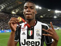 a soccer player is holding up his gold medal