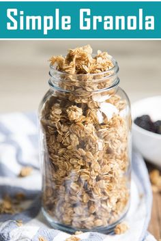 a glass jar filled with granola on top of a wooden table