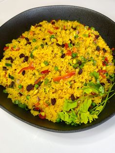 a pan filled with rice and vegetables on top of a table