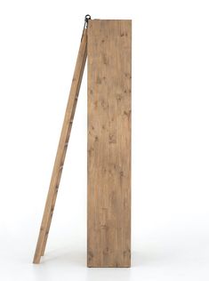 a wooden ladder leaning up against a white wall