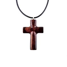 a wooden cross on a black cord necklace