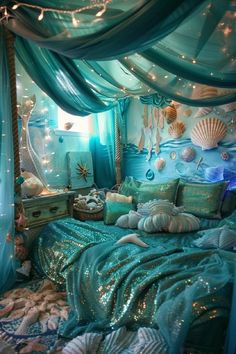 a bedroom decorated in blue and green with lots of sea shells on the bed, along with lights