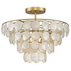 a chandelier with white shells hanging from it's golden metal frame and light fixture