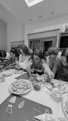 a group of people sitting around a table eating food