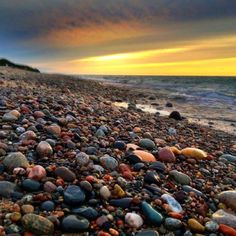 rocks on the beach with waves coming in to shore