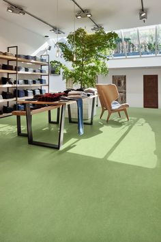 a room with green carpet and furniture in it