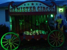 an old fashioned circus cart with clowns in it at night time, and people dressed as cats