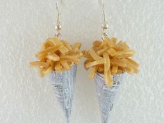 two cones of fries are hanging from silver earwires