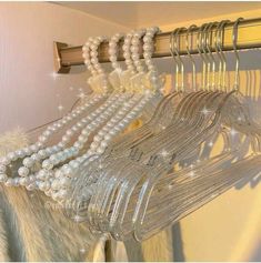 some white pearls are hanging from a rack