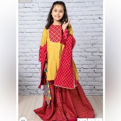 Gold Printed Shirt With Sheesha Embellishment Paired With Printed Gharara. 3 Piece Set. Comes With Kameez, Gharara And Potluck Cloth Bag. Brand New With Tags. Indian Pakistani Kids Designer Out. Size 4-5t. Mirror Work Embellishments. Yellow Sharara For Eid, Yellow Long Sleeve Sharara For Eid, Bollywood Style Yellow Cotton Sharara, Yellow Sharara With Dabka For Festivals, Yellow Dabka Sharara For Festivals, Yellow Dabka Sharara For Navratri, Yellow Cotton Sharara With Pallu, Bollywood Style Yellow Choli With Dabka, Yellow Cotton Sharara For Navratri