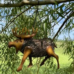 a wooden moose ornament hanging from a tree