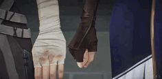 two people with their hands on each other's shoulders, one holding onto the hand of another person