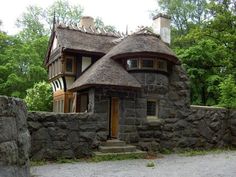 a stone house with a thatched roof