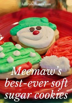 three decorated cookies on a red plate with the words meenau's best - ever soft sugar cookies