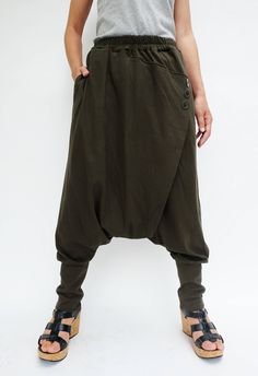 "🚚..ALL ORDERS ARE SHIPPED VIA DHL EXPRESS MAIL Relaxed fit dropped-crotch pants in olive. Asymmetric crossover fabric panel at front and back with 3 buttons front detailed. Elastic waistband and two hand pockets at side seam. Roll up the cuffed hem for an utlra relaxed look! * Pull-on style * Drop-crotch style * 2\" Elastic waistband * Side seam pockets * Wide cuffed hem Measurements approximately: Waist : 26\" (66 cm) stretching to 48\" (122 cm)-elastic material Hips : 50\" (122 cm) Outseam: Baggy High-waisted Khaki Harem Pants, Baggy High Waist Khaki Harem Pants, High Waist Baggy Khaki Harem Pants, Baggy Full-length Pants With Button Closure, Baggy Pants With Button Closure, Green Relaxed Fit Bottoms With Button Closure, Casual Baggy Pants With Buttons, Green Bottoms With Buttons For Fall, Green Fall Bottoms With Buttons