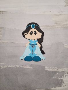 a cartoon doll sitting on top of a wooden floor