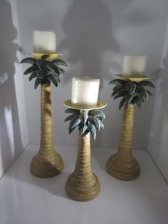 three candles with palm trees on them