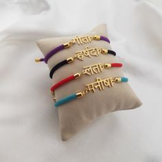 𝐻𝑜𝓌 𝒯𝑜 𝒪𝓇𝒹𝑒𝓇 - Choose cord color. - Leave the name/word in the personalization box in Marathi letters only. - You can use a virtual keyboard:  https://www.lexilogos.com/keyboard/devanagari.htm - Up to 11 characters. 𝐼𝓉𝑒𝓂 𝒟𝑒𝓈𝒸𝓇𝒾𝓅𝓉𝒾𝑜𝓃 Marathi Name Bracelet. Name dimensions: height: 7-9mm, width 15-35mm. Bracelet length: adjustable up to 7". 𝒪𝓇𝒹𝑒𝓇 𝐻𝒶𝓃𝒹𝓁𝒾𝓃𝑔 𝒯𝒾𝓂𝑒 Order processing time for our items is 3-5 business days, please note it does not include the del Traditional Adjustable Personalized Bracelets, Festive Adjustable Personalized Bracelets, Multicolor Spiritual Bracelets For Puja, Spiritual Multicolor Bracelets For Puja, Spiritual Friendship Bracelets As Festival Gifts, Traditional Gold Friendship Bracelets For Festivals, Traditional Personalized Bracelet As Gift, Marathi Letters, Nameplate Bracelet