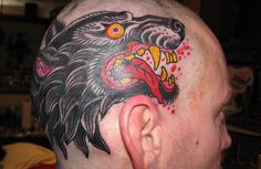 a man with a tattoo on his head has an eagle and snake on it's forehead