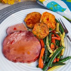 a white plate topped with meat and veggies