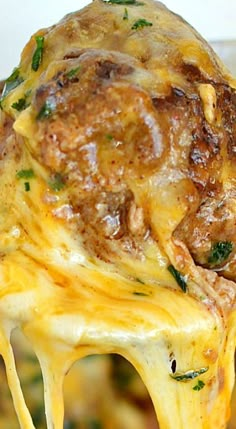 a close up of food being lifted from a casserole dish