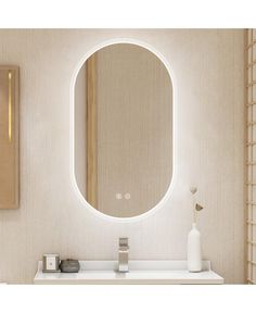 a bathroom with a round mirror on the wall and a white counter top in front of it