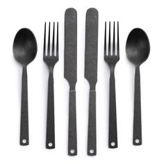 four forks, two spoons and one knife on a white surface