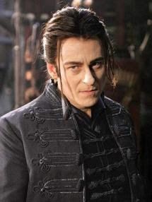 a man with long hair wearing a black jacket