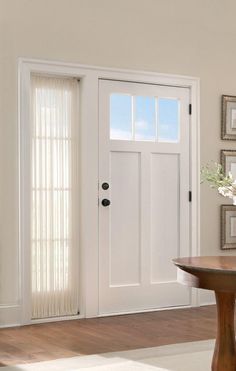 a white front door with two sidelights and a table in the middle of it