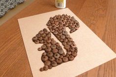 a wooden table topped with lots of chocolate chips next to a can of coffee beans