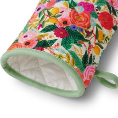 an image of a colorful flowered bag on a white background with green trimming