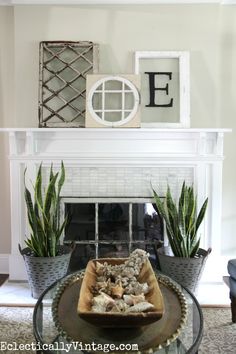 a living room filled with furniture and a fire place covered in plants next to a fireplace