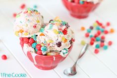 two scoops of ice cream with sprinkles and cereal in a red bowl