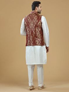 A gold zari brocade vest to pair with any kurta with statement button closures at the front. Occasion: Style this vest with pajama pants and a kurta for a welcome dinner or sangeet night, or style it with a any dress shirt and trousers for a sleek Indian wedding reception look! WASH CARE INSTRUCTIONS - Please Dry clean only. Slight color variation is possible due to digital photography. **Kurta & Pajama not included Sleeveless Nehru Jacket With Zari Work For Transitional Season, Sleeveless Nehru Jacket With Zari Work, Traditional Sleeveless Kurta With Zari Work, Designer Sleeveless Kurta For Transitional Season, Sleeveless Bandhgala For Eid, Traditional Sleeveless Kurta For Festivities, Designer Sleeveless Kurta For Eid, Bollywood Style Sleeveless Kurta For Festivals, Brocade Nehru Jacket For Diwali Designer Wear