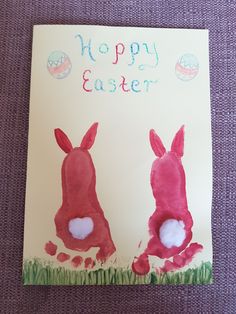 an easter card with two rabbits painted on it