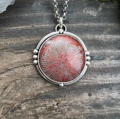 Gorgeous Red Horn coral from Utah set in sterling and fine silver on an 18" sterling chain.  Pendant measures approximately 1 5/16" diameter. Red Coral Round Necklace For Gift, Round Red Coral Necklace For Gift, Unique White Gold Nickel-free Necklace, Unique Round White Gold Necklaces, Elegant Coral Sterling Silver Jewelry, Unique Necklace With Sterling Silver Clasp, Unique Necklaces With Sterling Silver Clasp, Elegant Round Coral Necklace, Elegant Coral Round Necklace