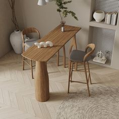 a wooden table with two chairs next to it and a potted plant in the corner