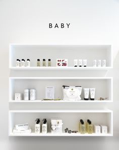 the shelves are filled with different types of skin care products and baby goods on them