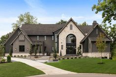 a large house with lots of windows and landscaping