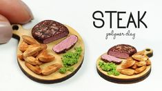 a person is holding a wooden plate with food on it and the words steak spelled out