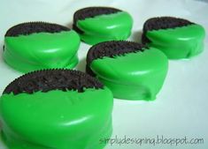 four green cookies with chocolate chips in the middle