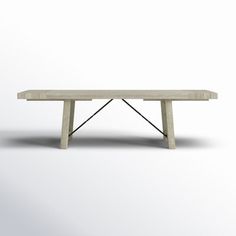 a white table with two legs and a long wooden bench on the top, in front of a light gray background