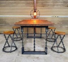 a table with four stools and a lamp on it in front of a garage door