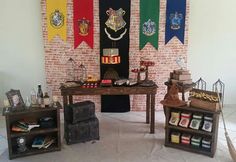 a table with harry potter flags on it and other items in front of the wall