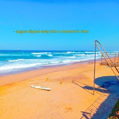 there is a life guard stand on the beach next to the water and an ocean