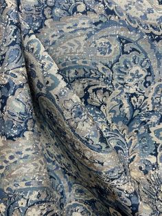 the fabric is blue and white with an intricate pattern