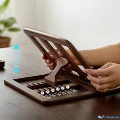 a person using a tabletop on a wooden table