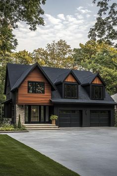 a large house with two car garages on the front and second story, surrounded by trees